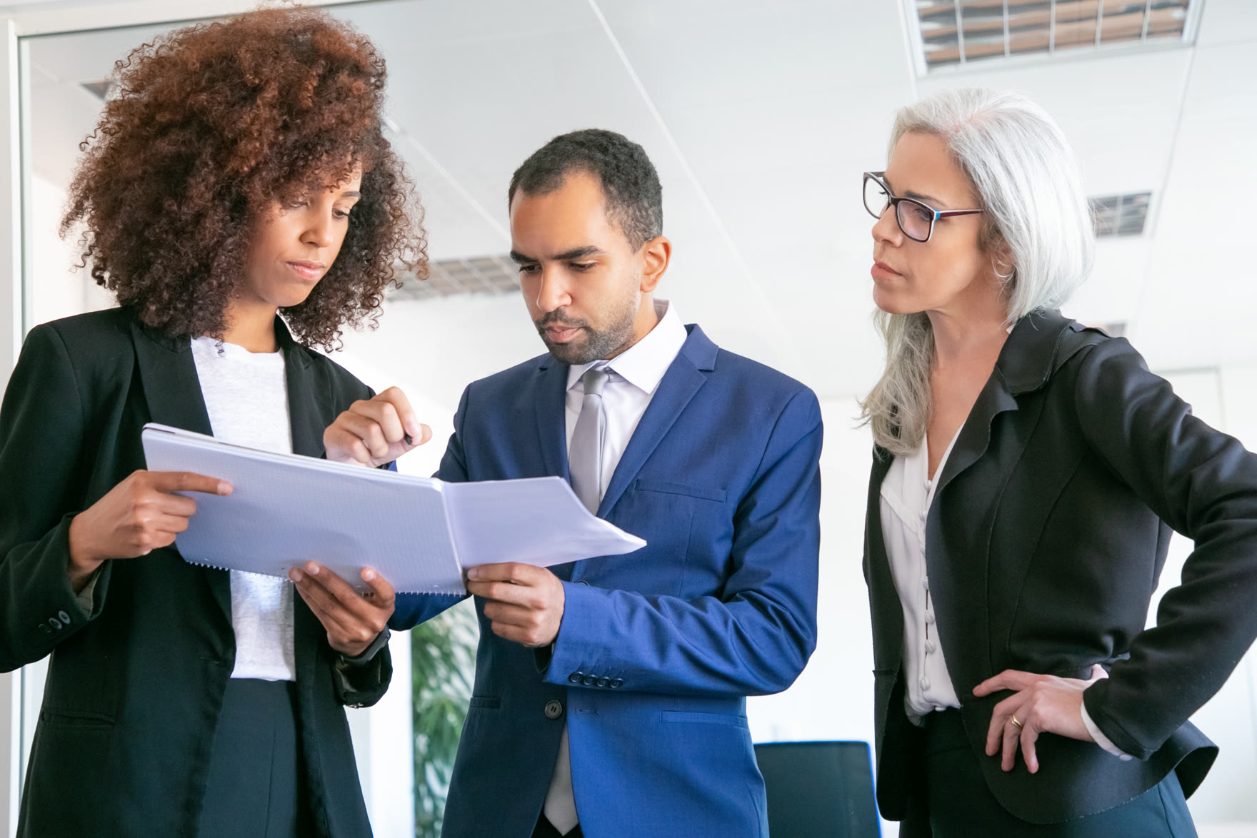 Professionals reviewing corporate documents and indicators